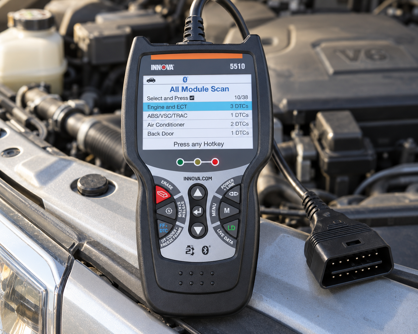 Innova 5510 OBD2 diagnostic scanner in the engine bay of a silver SUV
