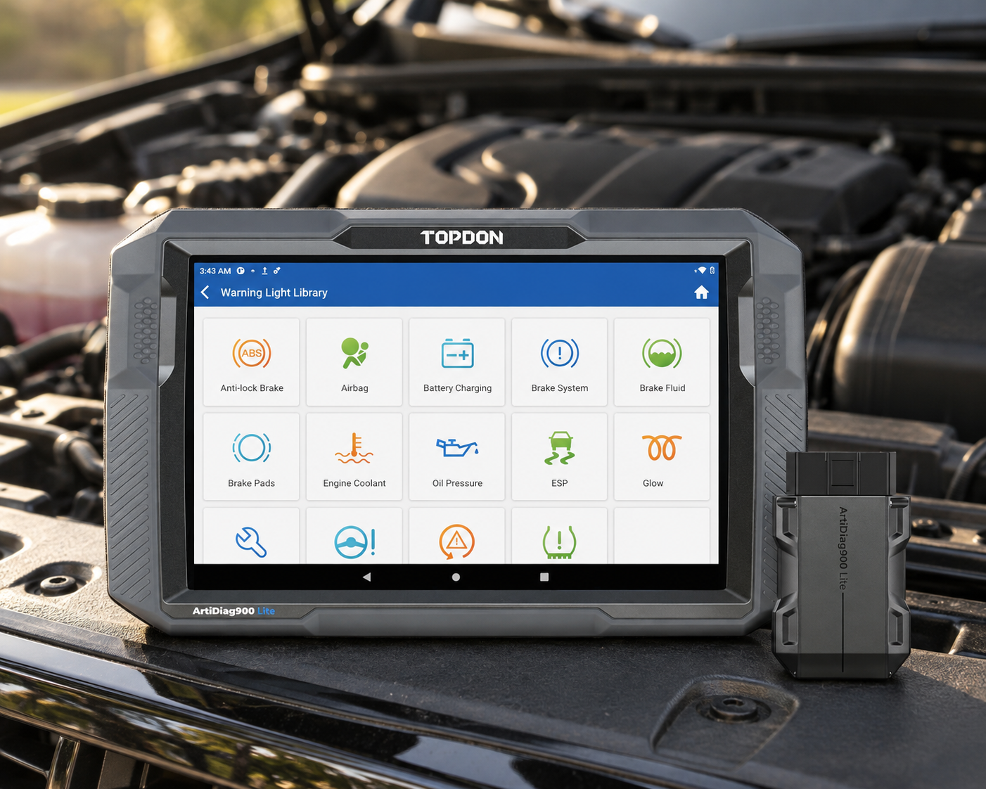 TOPDON ArtiDiag900 Lite diagnostic scanner with VCI in the engine bay of a black sedan