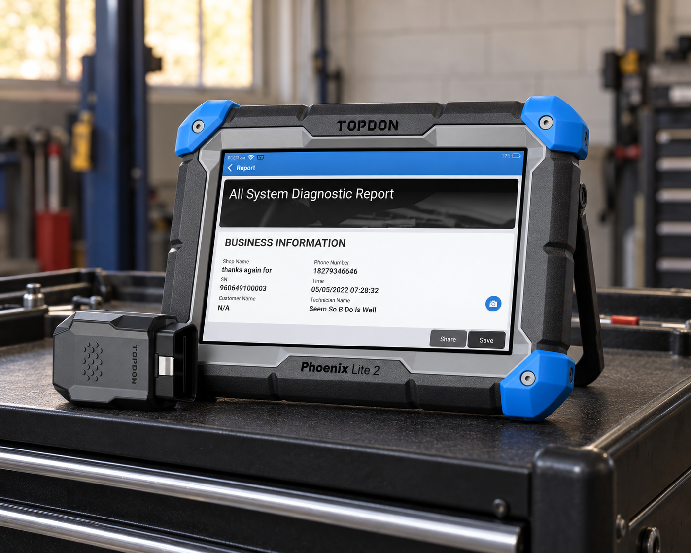 TOPDON Phoenix Lite 2 diagnostic tablet with VCI on a black mechanic tool cart in a workshop