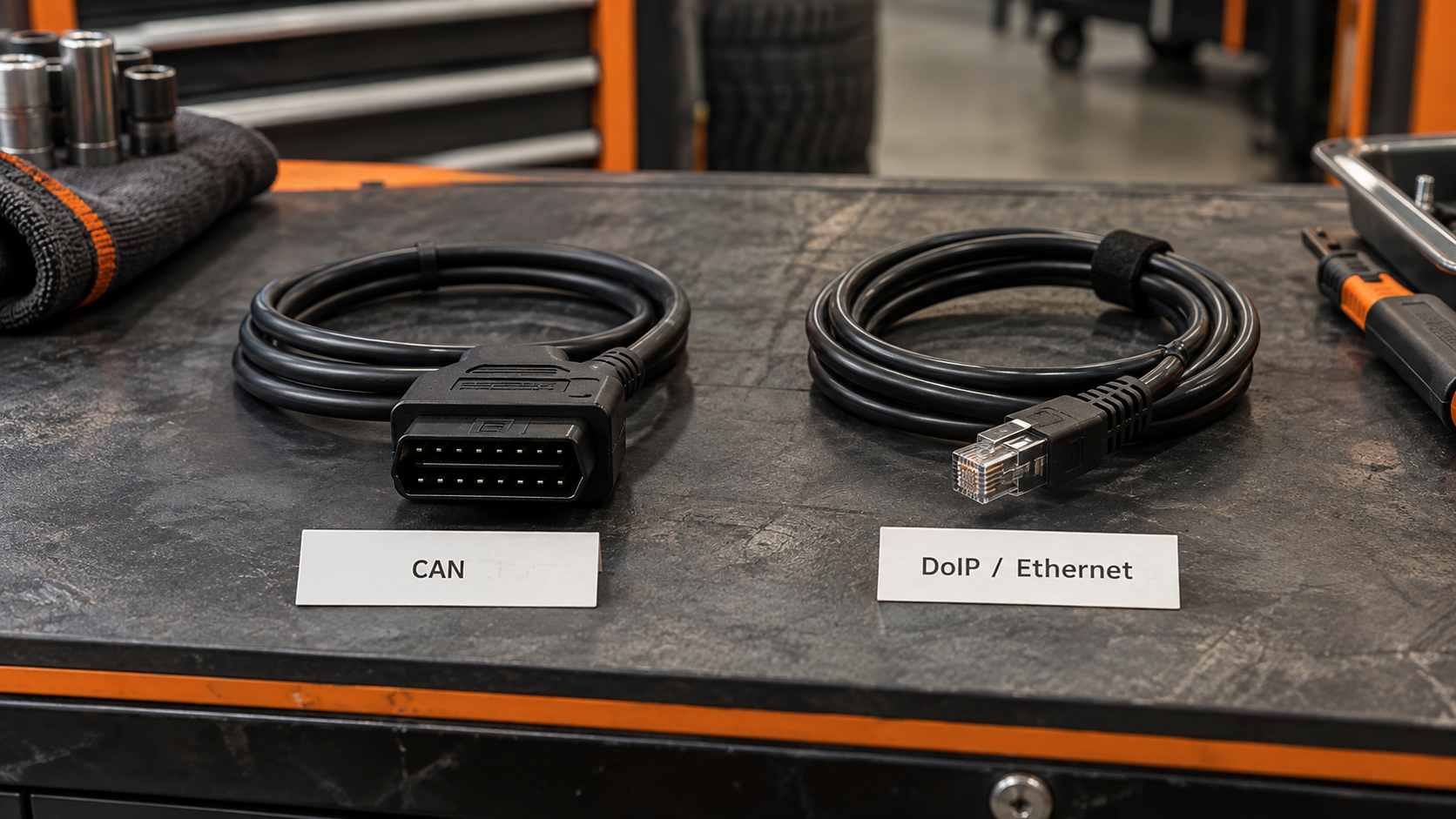 CAN OBD2 cable and DoIP Ethernet diagnostic cable displayed side by side on a workshop bench.